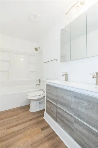 a bathroom with a sink a toilet and bathtub