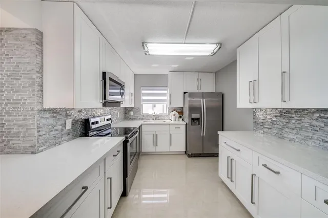 a kitchen with a sink stove and refrigerator