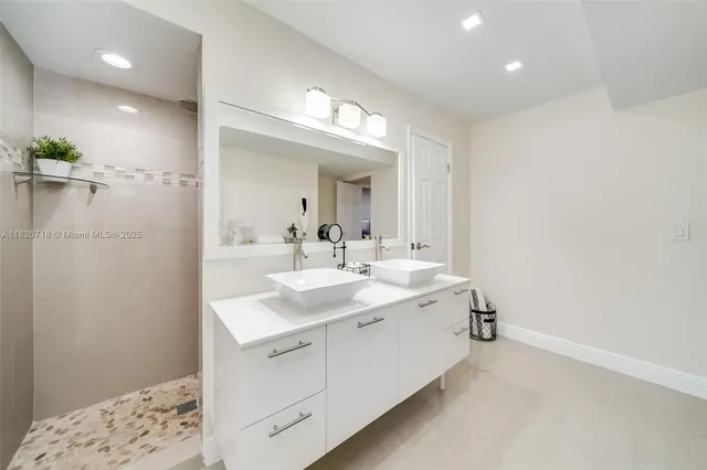 a bathroom with a sink double vanity and a mirror