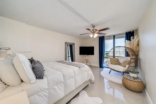 a bedroom with a bed furniture and a flat screen tv