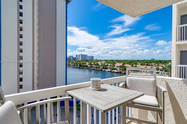 a view of a balcony dining table and chairs
