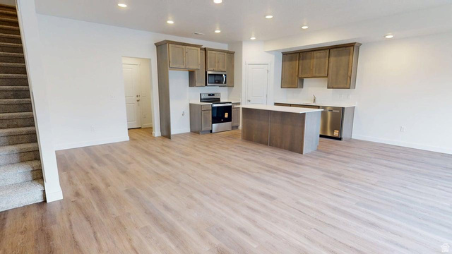 777 Pheasantbrook Drive, Unit 2B Centerville, UT 84014 - Photo 6 of 42 Open-concept living space featuring wood-finish flooring, recessed lighting, and a neutral color palette