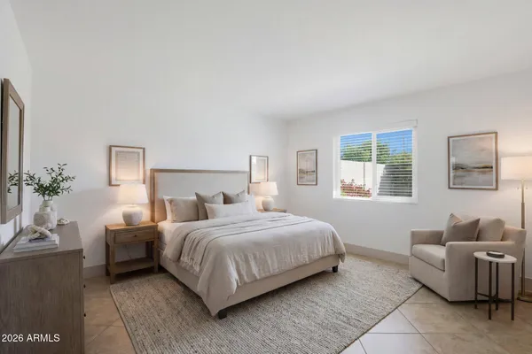 a bedroom with a bed and a couch
