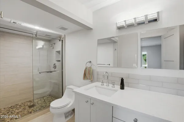 a bathroom with a sink toilet and shower