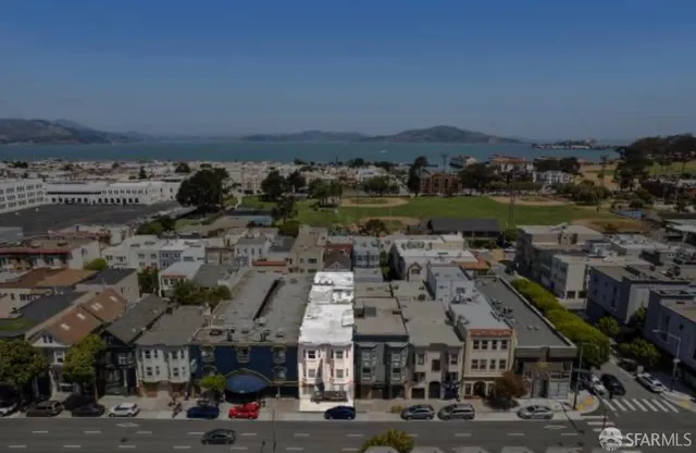 an aerial view of a building with a mountain
