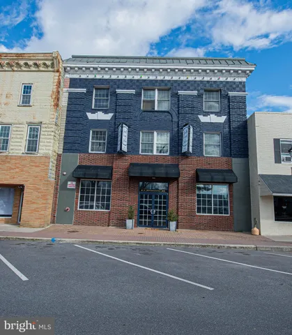 front view of a brick house with a street