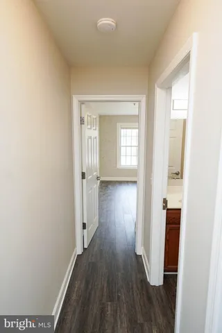 a view of hallway with wooden floor
