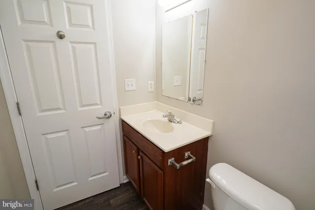 a bathroom with a sink a toilet and vanity