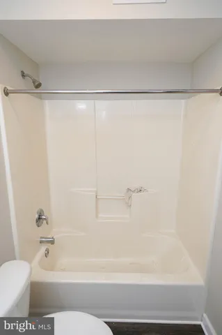 a bathroom with a shower and a bath tub