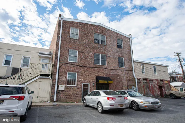 a car parked in front of a brick house