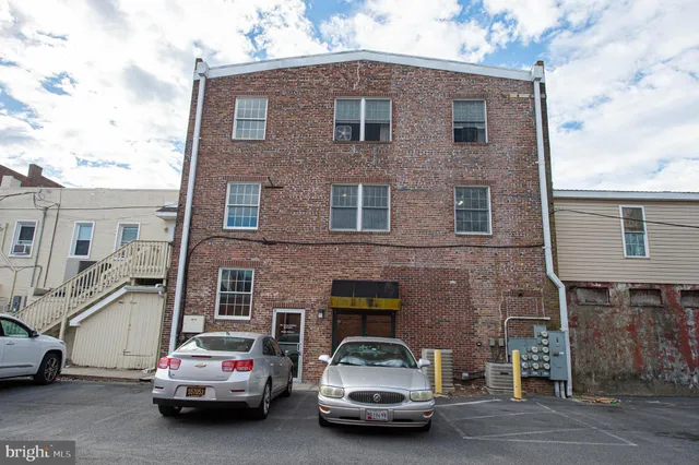 a car parked in front of a brick house