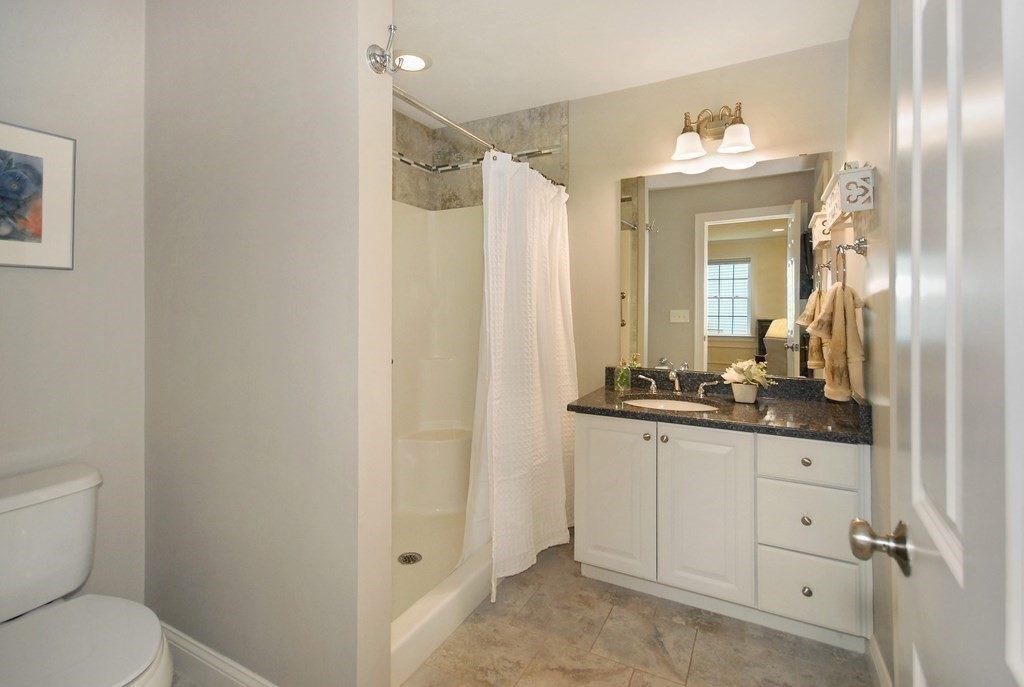 17 Marble Farm Road, Unit 17 Maynard, MA 01754 - Photo 13 of 26 a bathroom with a granite countertop sink mirror vanity and toilet