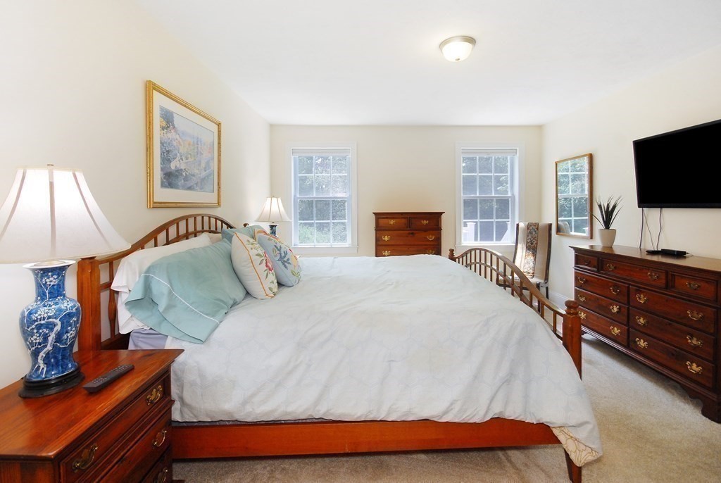 17 Marble Farm Road, Unit 17 Maynard, MA 01754 - Photo 15 of 26 a bedroom with a bed and a flat screen tv