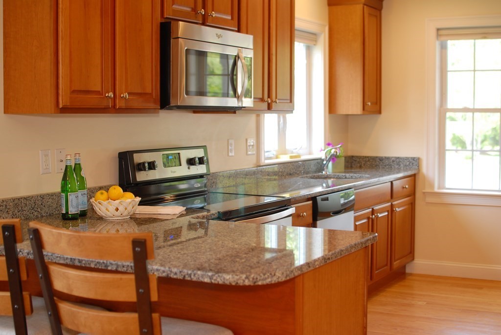 17 Marble Farm Road, Unit 17 Maynard, MA 01754 - Photo 6 of 26 a kitchen with stainless steel appliances granite countertop a sink and a white cabinets