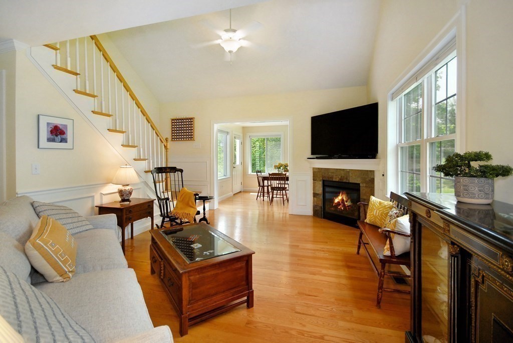 17 Marble Farm Road, Unit 17 Maynard, MA 01754 - Photo 8 of 26 a living room with furniture a fireplace and a flat screen tv
