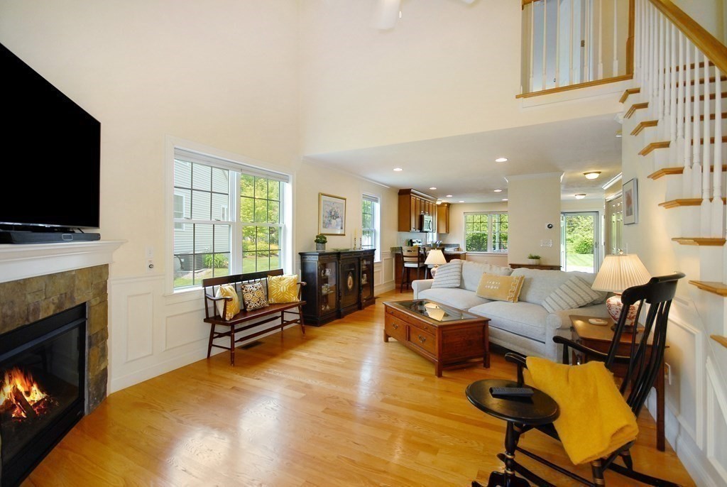 17 Marble Farm Road, Unit 17 Maynard, MA 01754 - Photo 9 of 26 a living room with fireplace furniture and a flat screen tv