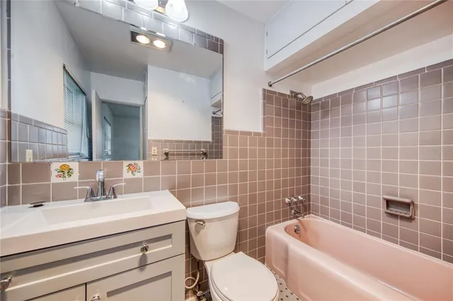 an empty room with a ceiling fan and windows