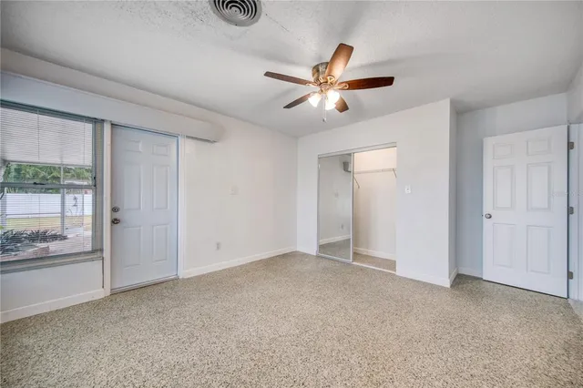 a view of yard with swimming pool and trees in the background