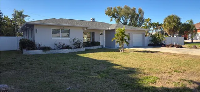 a large kitchen with a refrigerator a sink stainless steel appliances and a large window