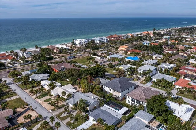 an empty room with chandelier fan and windows