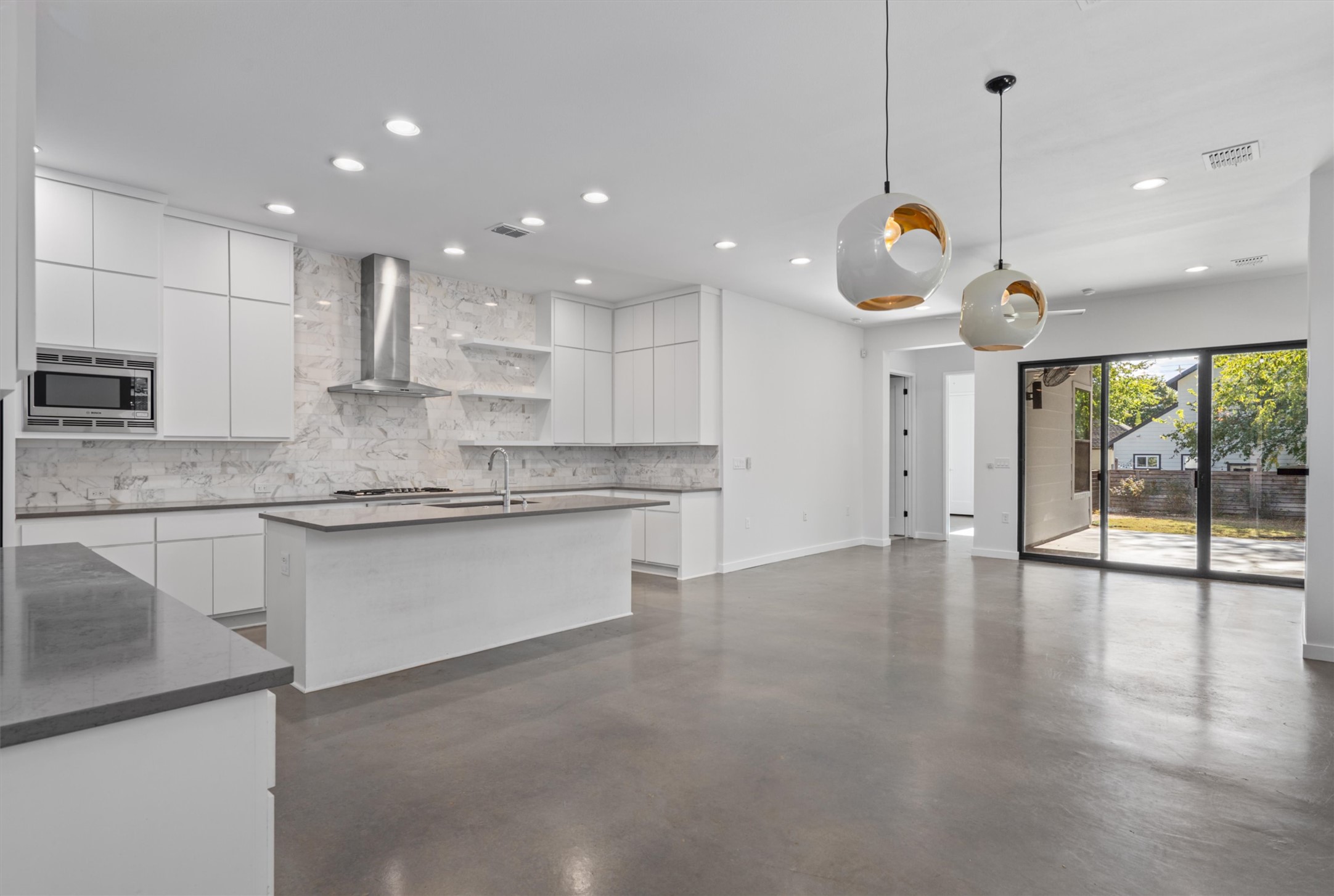 1107 Taulbee Lane, Unit B Austin, TX 78757 - Photo 8 of 37 Open living, dining and kitchen space with access to backyard