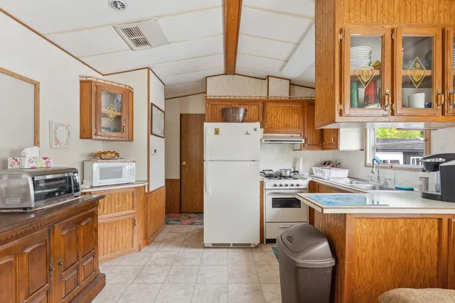 a kitchen with a sink appliances and cabinets