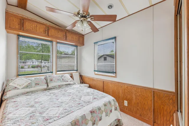 a bedroom with a large bed and a window