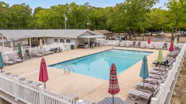 a view of a house with swimming pool and sitting area