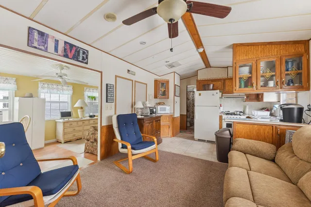 a living room with furniture a fireplace and a large window