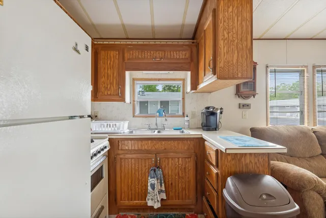a dining room with furniture a window and kitchen view
