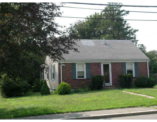 a view of a house with a yard and potted plants