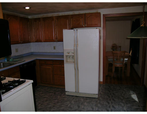 232 Pleasant Street Melrose, MA 02176 - Photo 4 of 8 a kitchen with a refrigerator stove and cabinets