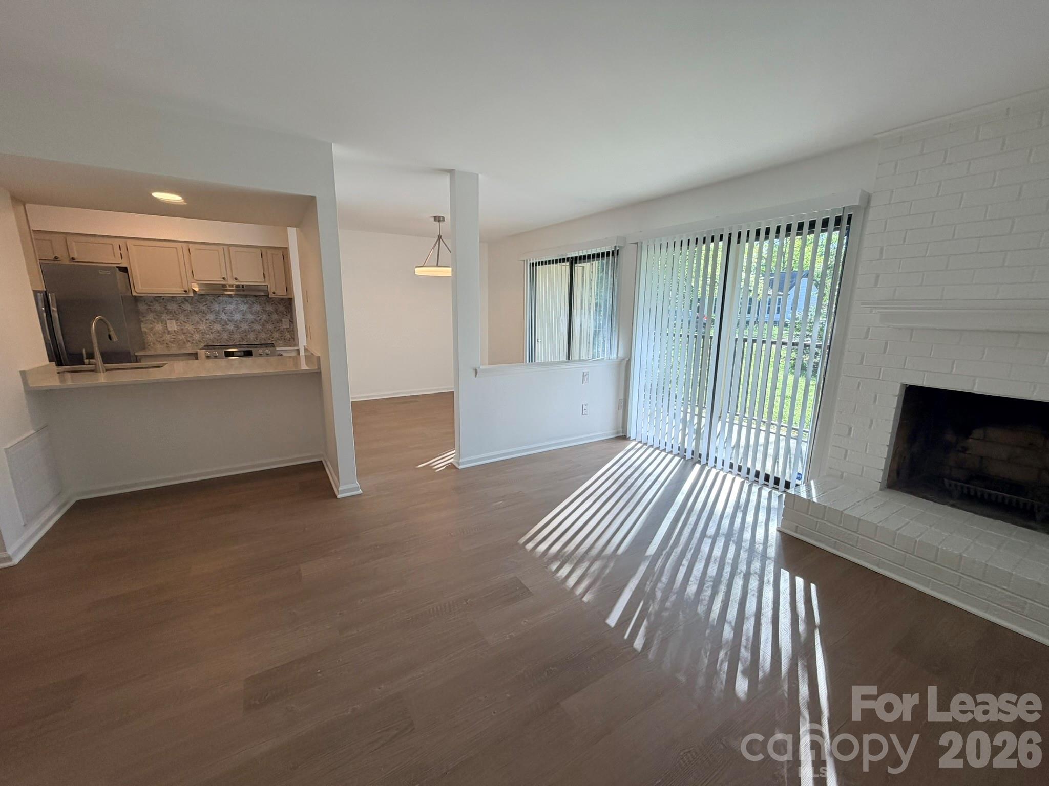 a view of a livingroom with furniture and floor to ceiling window