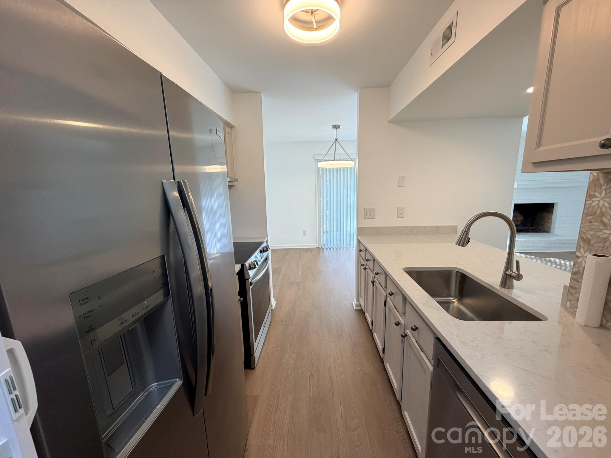 11048 Cedar View Road Charlotte, NC 28226 - Photo 3 of 8 a kitchen with sink a refrigerator and washer