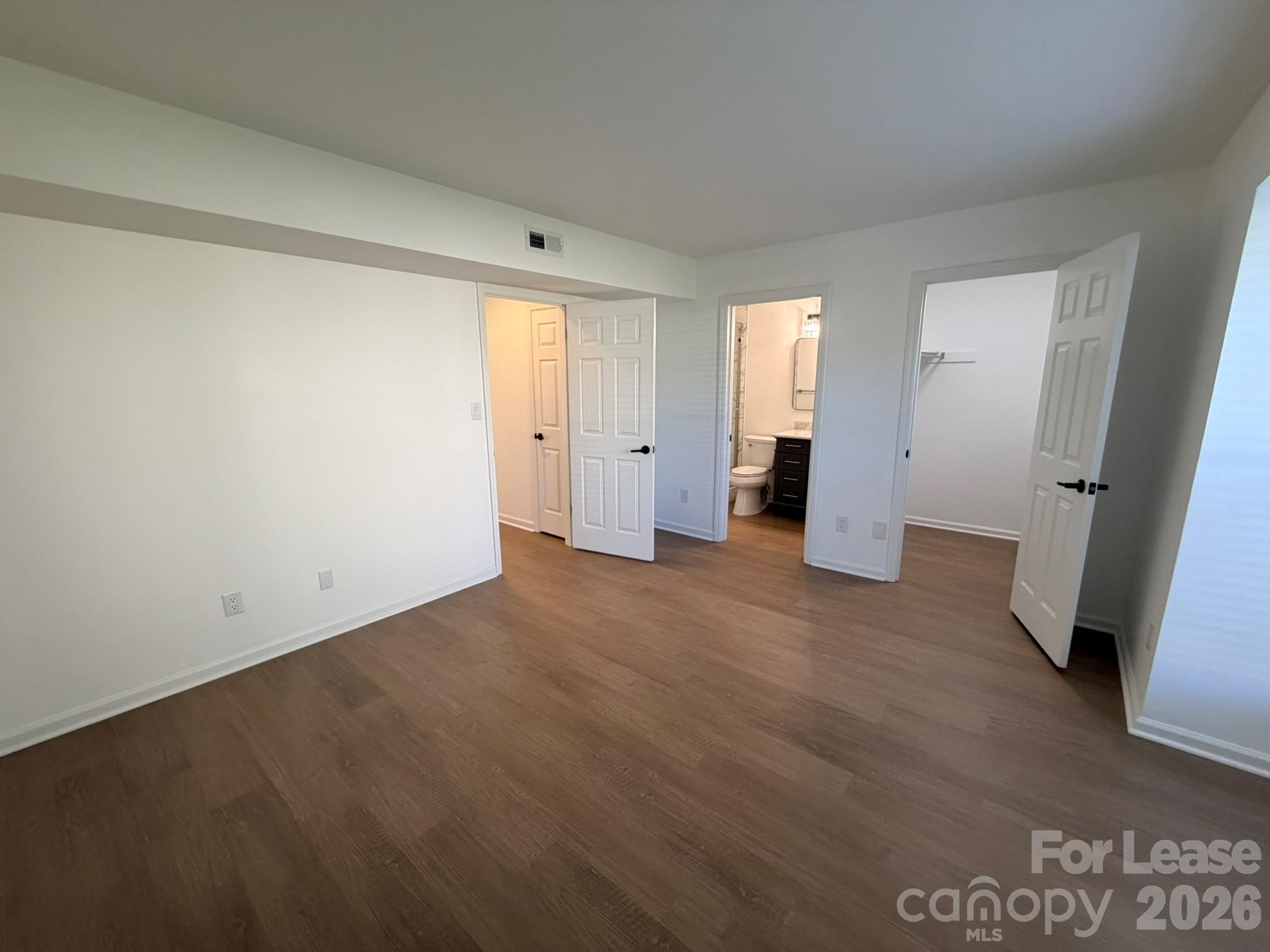 11048 Cedar View Road Charlotte, NC 28226 - Photo 6 of 8 an empty room with wooden door and closet