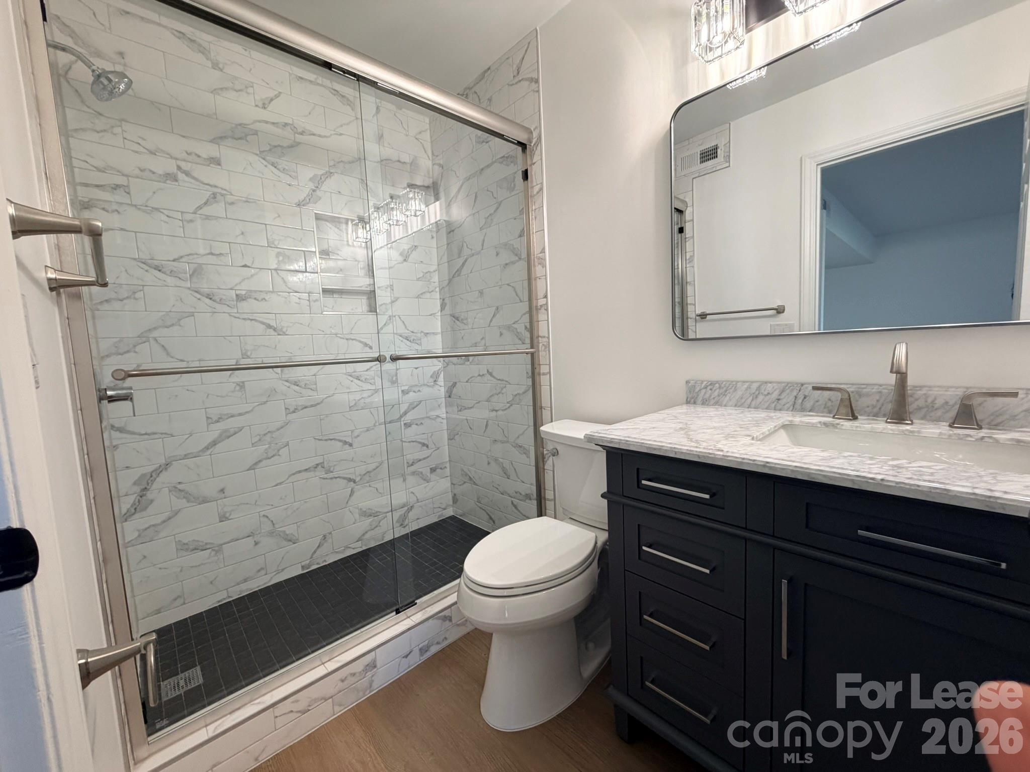 11048 Cedar View Road Charlotte, NC 28226 - Photo 7 of 8 a bathroom with a sink a toilet and shower