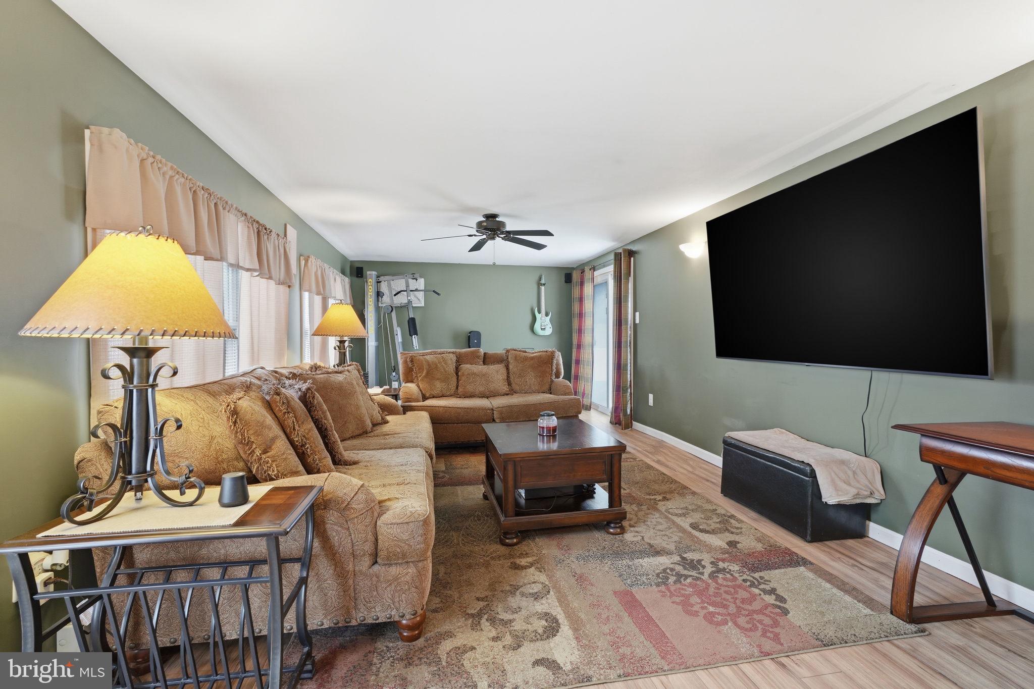 396 Pinewood Drive Levittown, PA 19054 - Photo 15 of 32 a living room with furniture and a flat screen tv