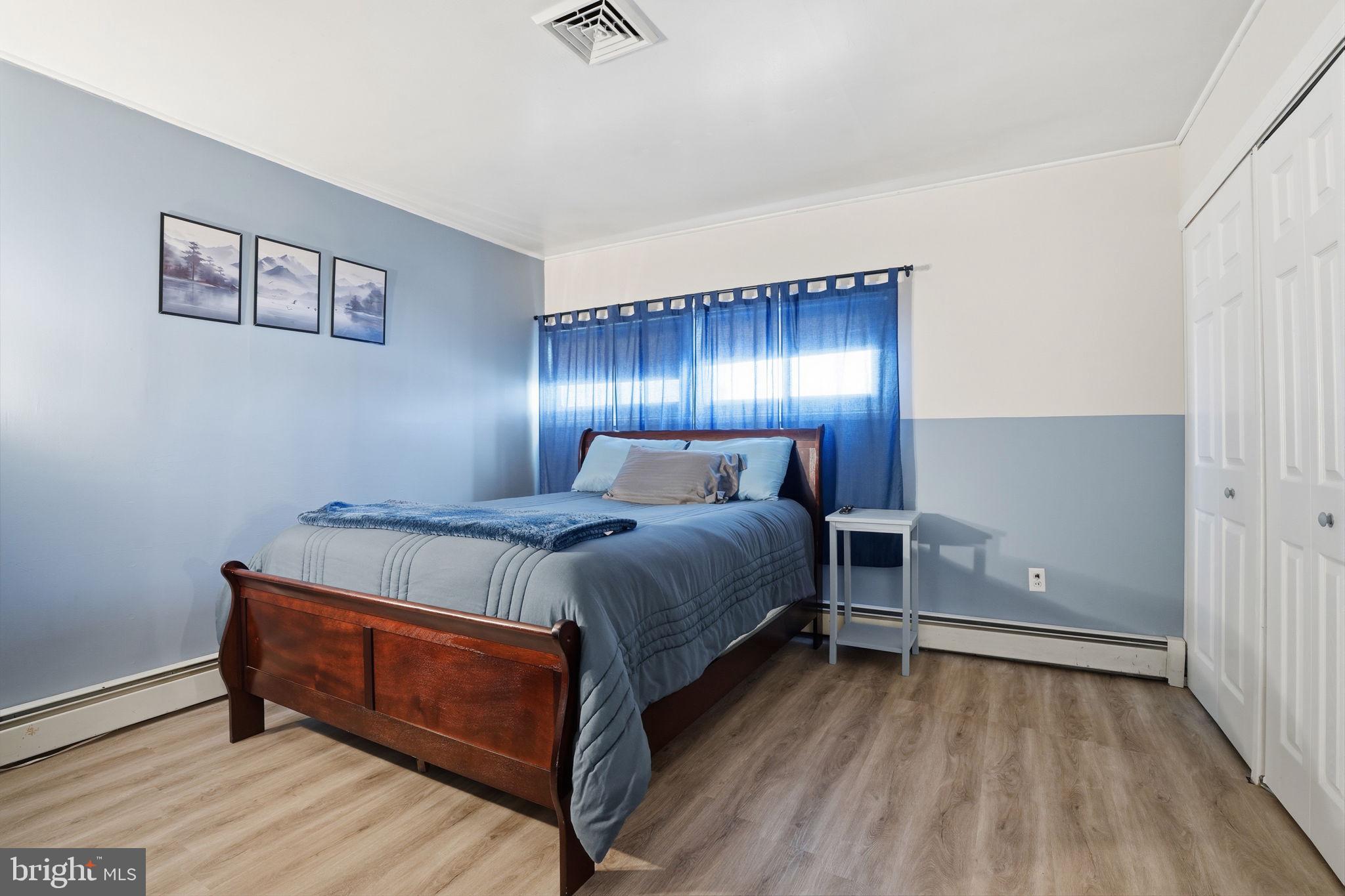 396 Pinewood Drive Levittown, PA 19054 - Photo 22 of 32 a bedroom with a bed and wooden floor