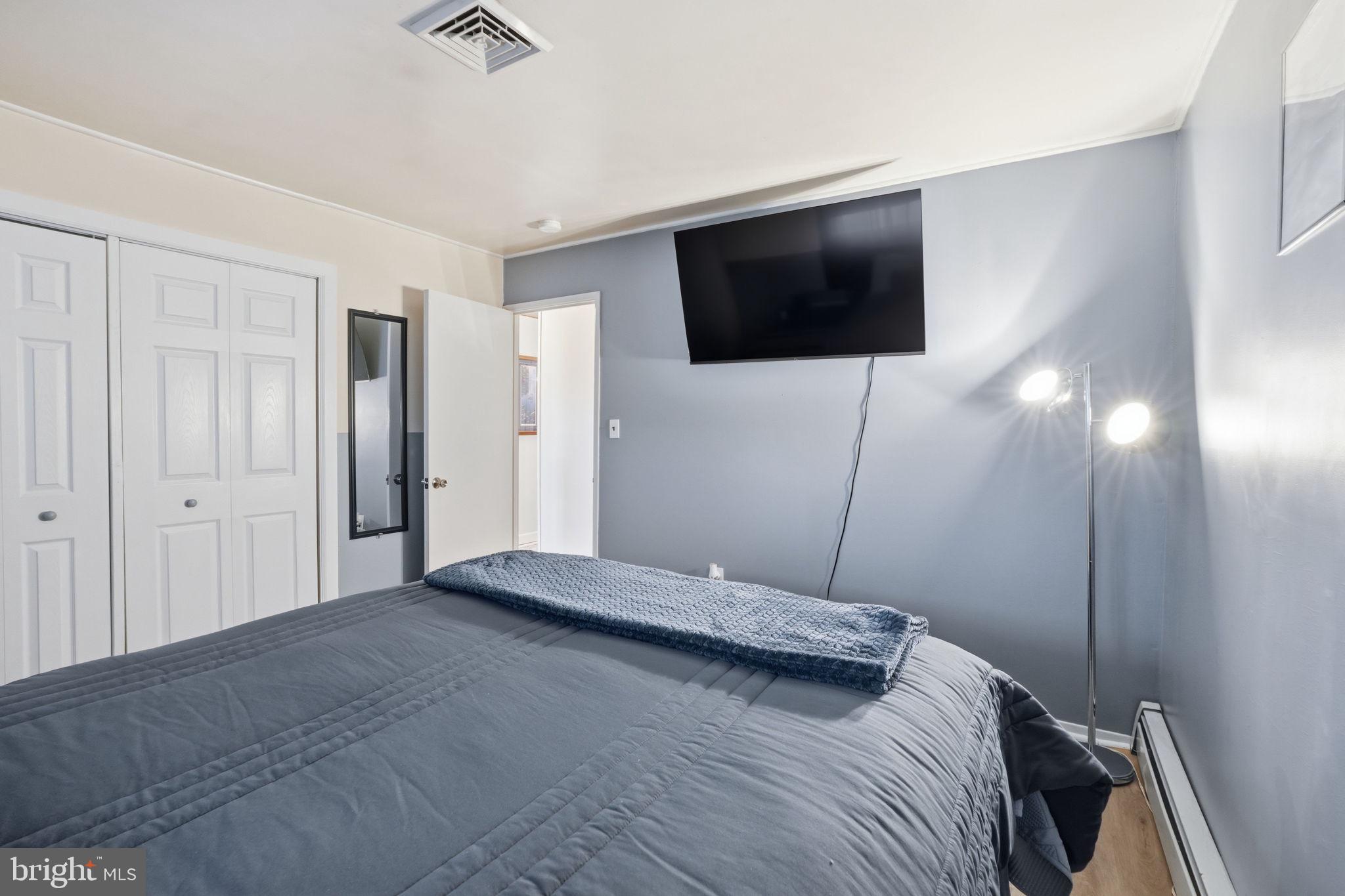 396 Pinewood Drive Levittown, PA 19054 - Photo 23 of 32 a bedroom with a bed and a flat screen tv