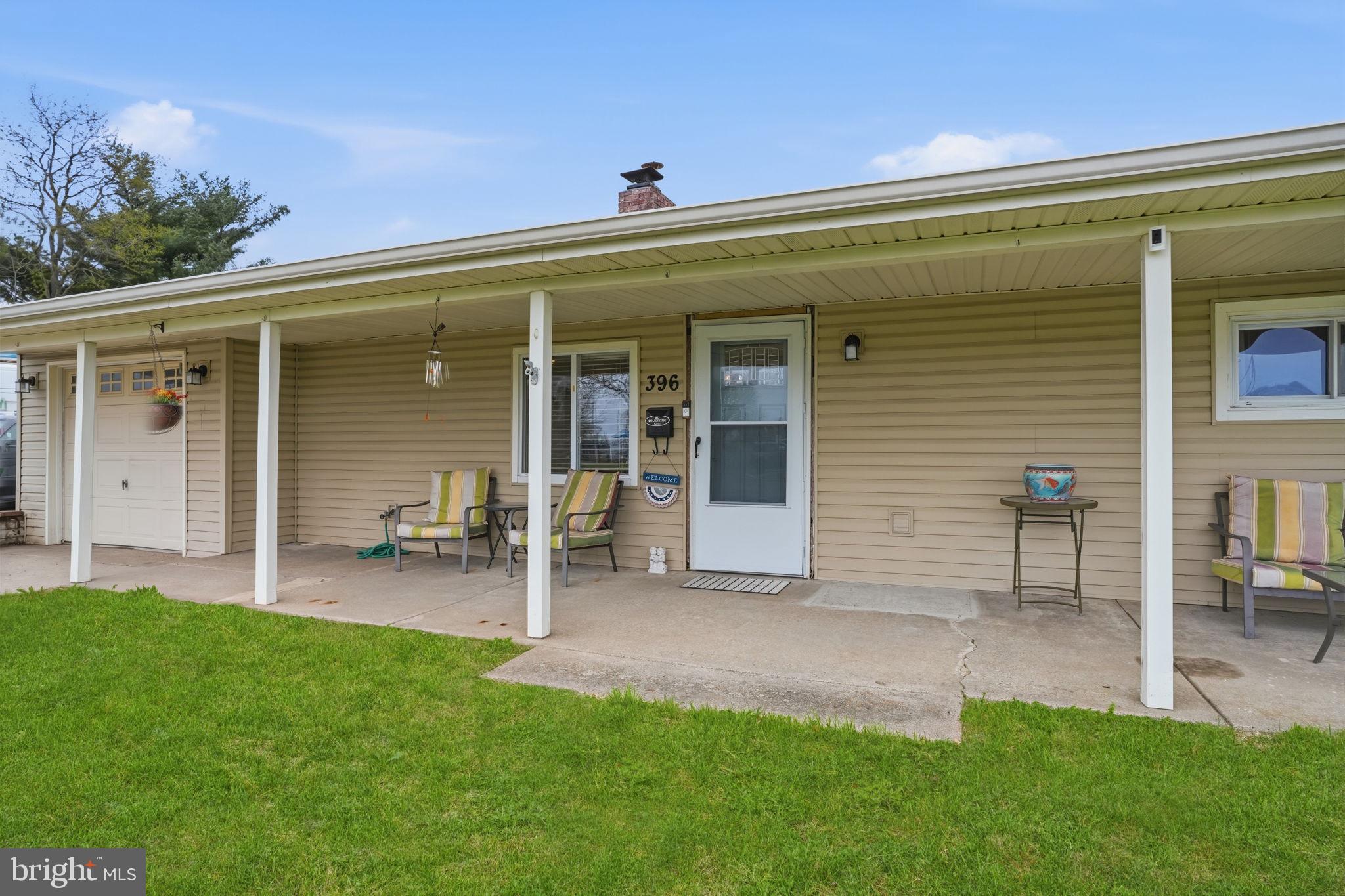 396 Pinewood Drive Levittown, PA 19054 - Photo 4 of 32 a view of a backyard with a patio and a garden