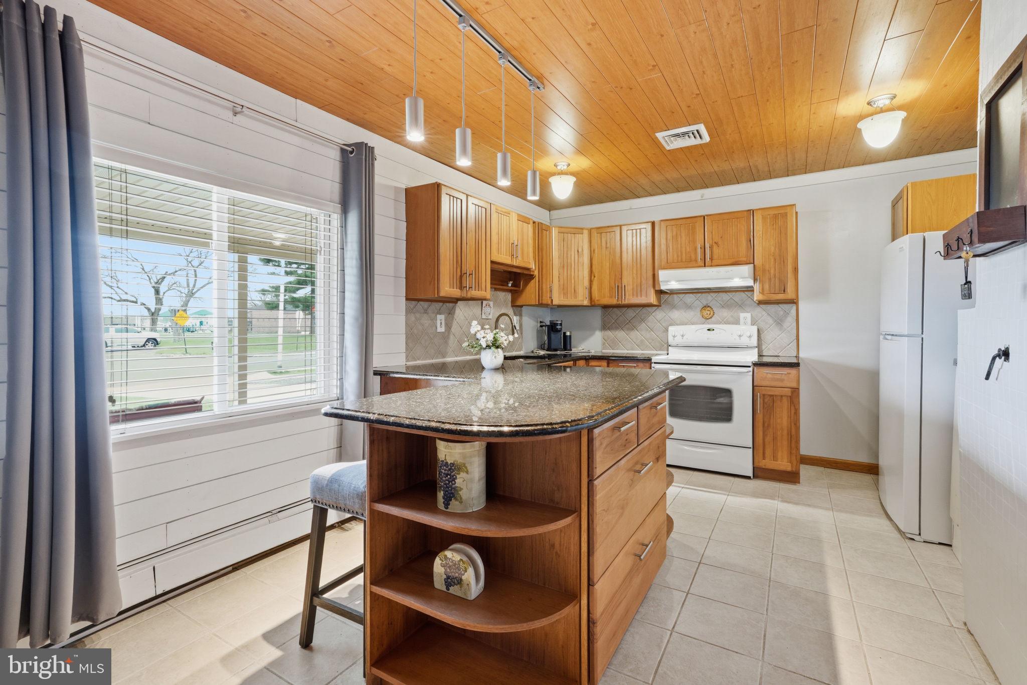 396 Pinewood Drive Levittown, PA 19054 - Photo 5 of 32 a kitchen with stainless steel appliances granite countertop a stove a sink and a refrigerator