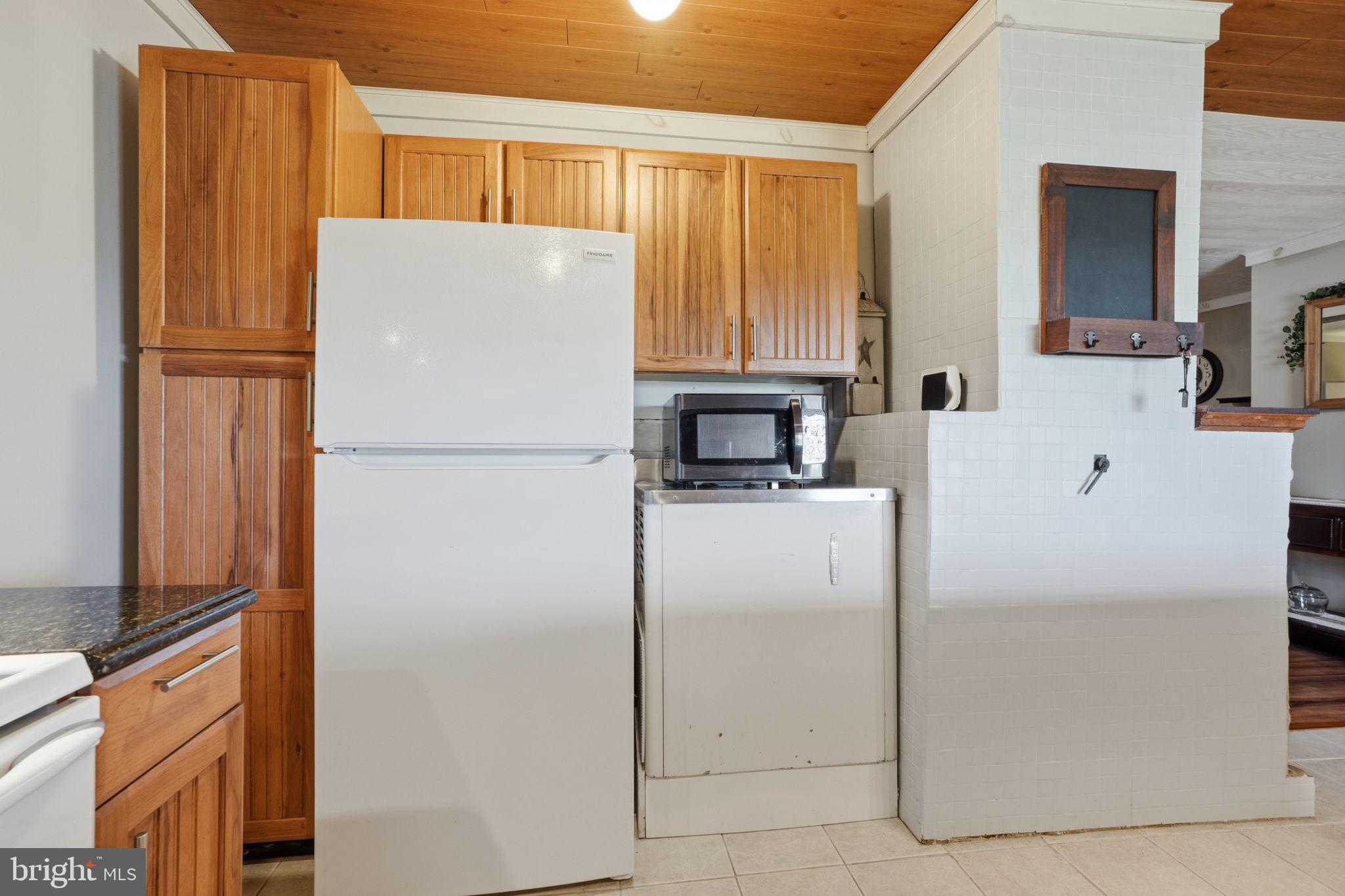 396 Pinewood Drive Levittown, PA 19054 - Photo 7 of 32 a white refrigerator freezer and a stove top oven