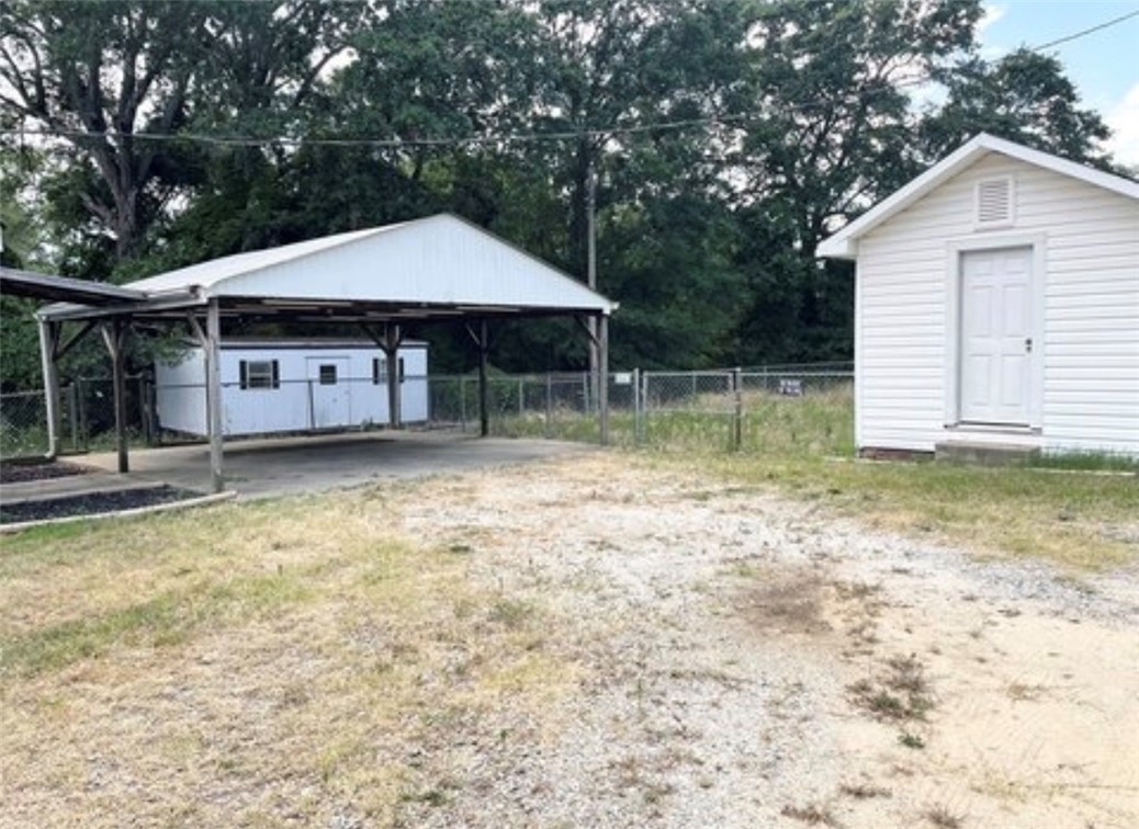 208 Hampton Street Iva, SC 29655 - Photo 18 of 19 This property offers a versatile outdoor space with a carport and additional structure.