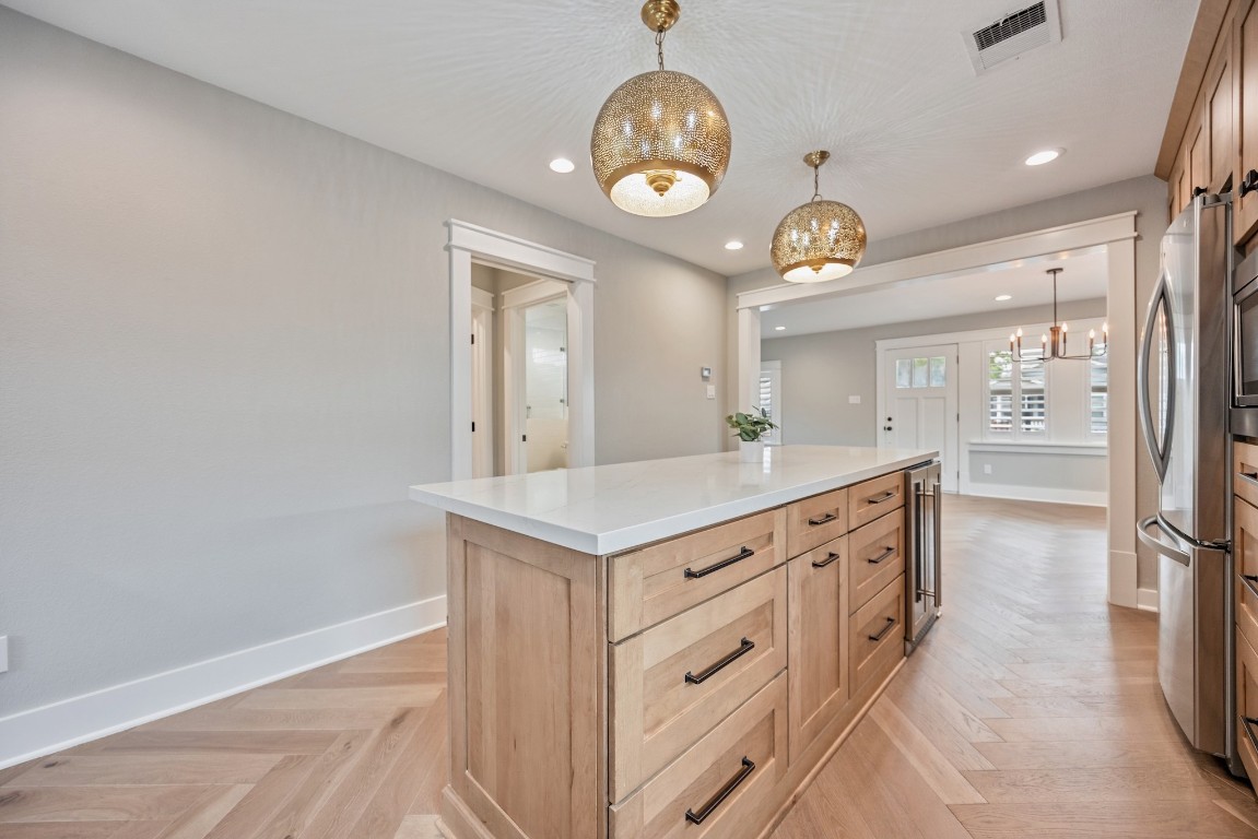 1104 Walton Street Houston, TX 77009 - Photo 12 of 27 The heart of the home includes a Zepher wine refrigerator, an island perfect for barstools, and clever storage solutions like a pull-out trash container.