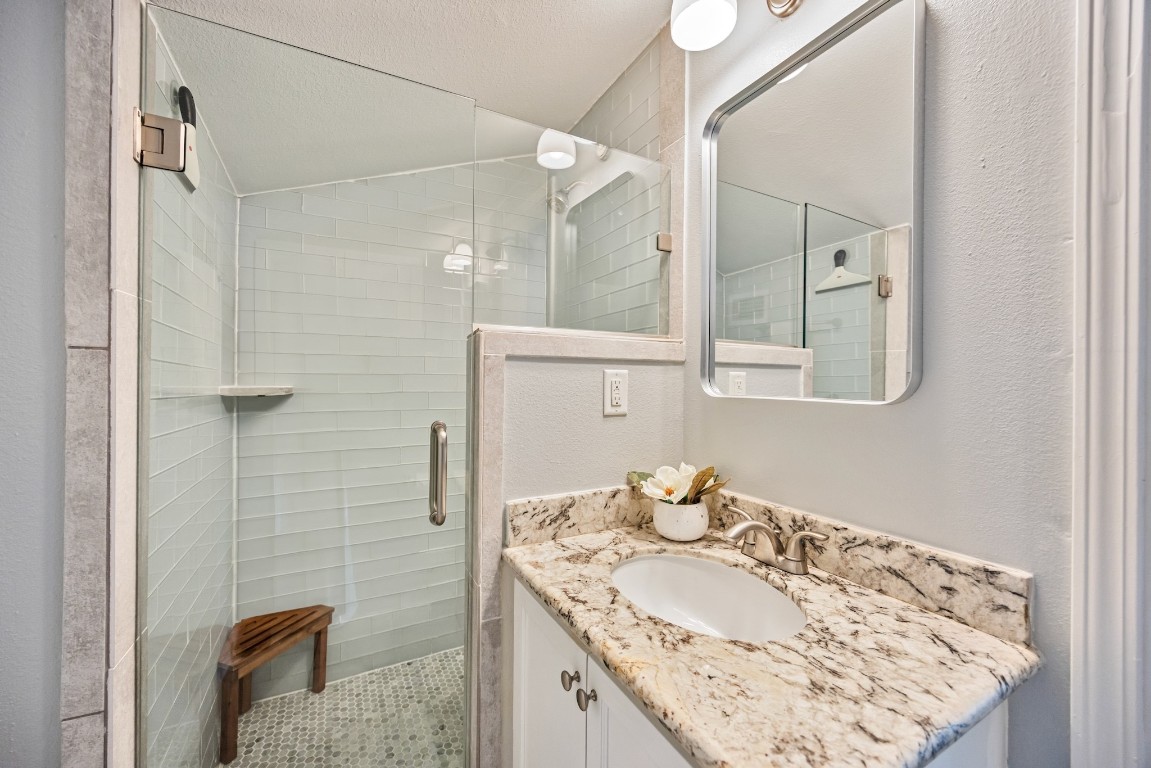 1104 Walton Street Houston, TX 77009 - Photo 20 of 27 A chic and efficient primary bathroom features a stylish step-in shower.