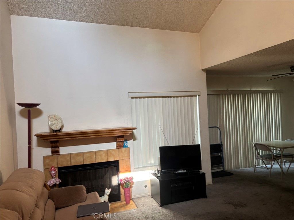 15809 Fallen Leaf Road La Puente, CA 91744 - Photo 4 of 23 a living room with furniture a flat screen tv and a fireplace