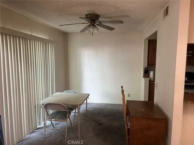 a view of a hallway with furniture and a window