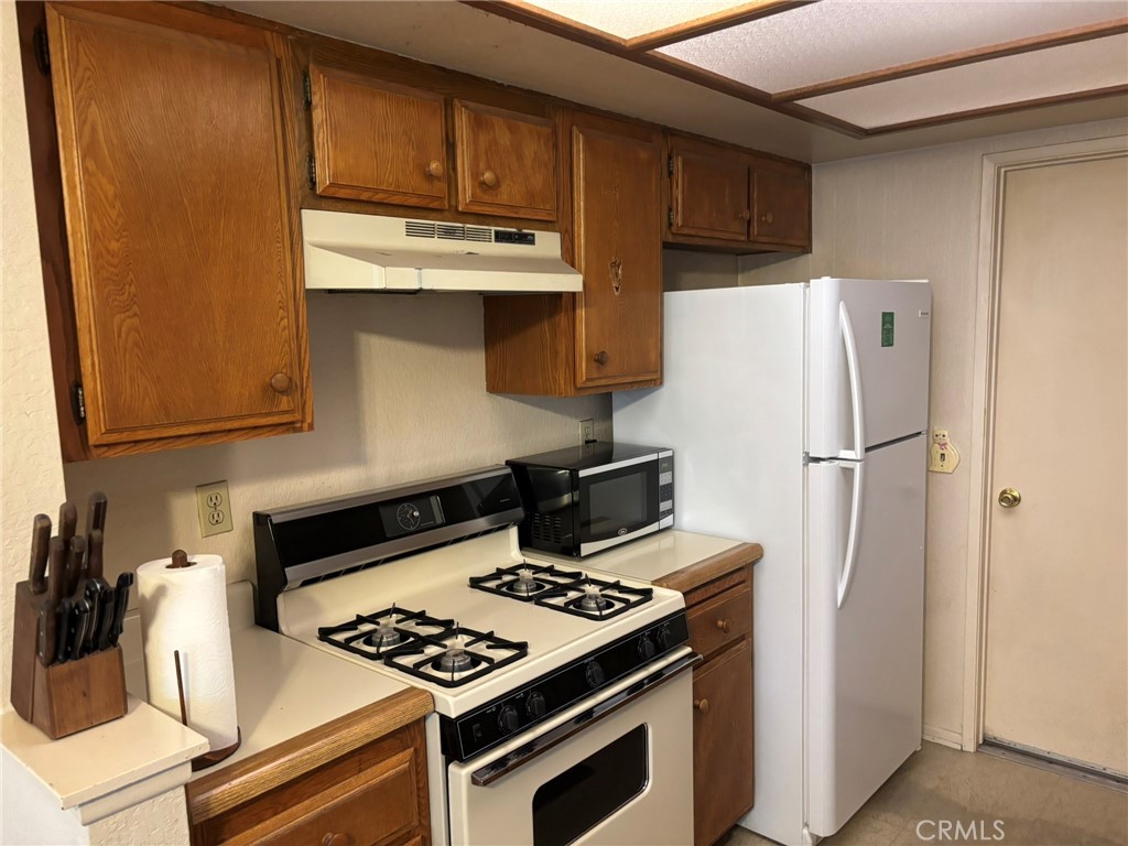 15809 Fallen Leaf Road La Puente, CA 91744 - Photo 10 of 23 a kitchen with a refrigerator and a stove
