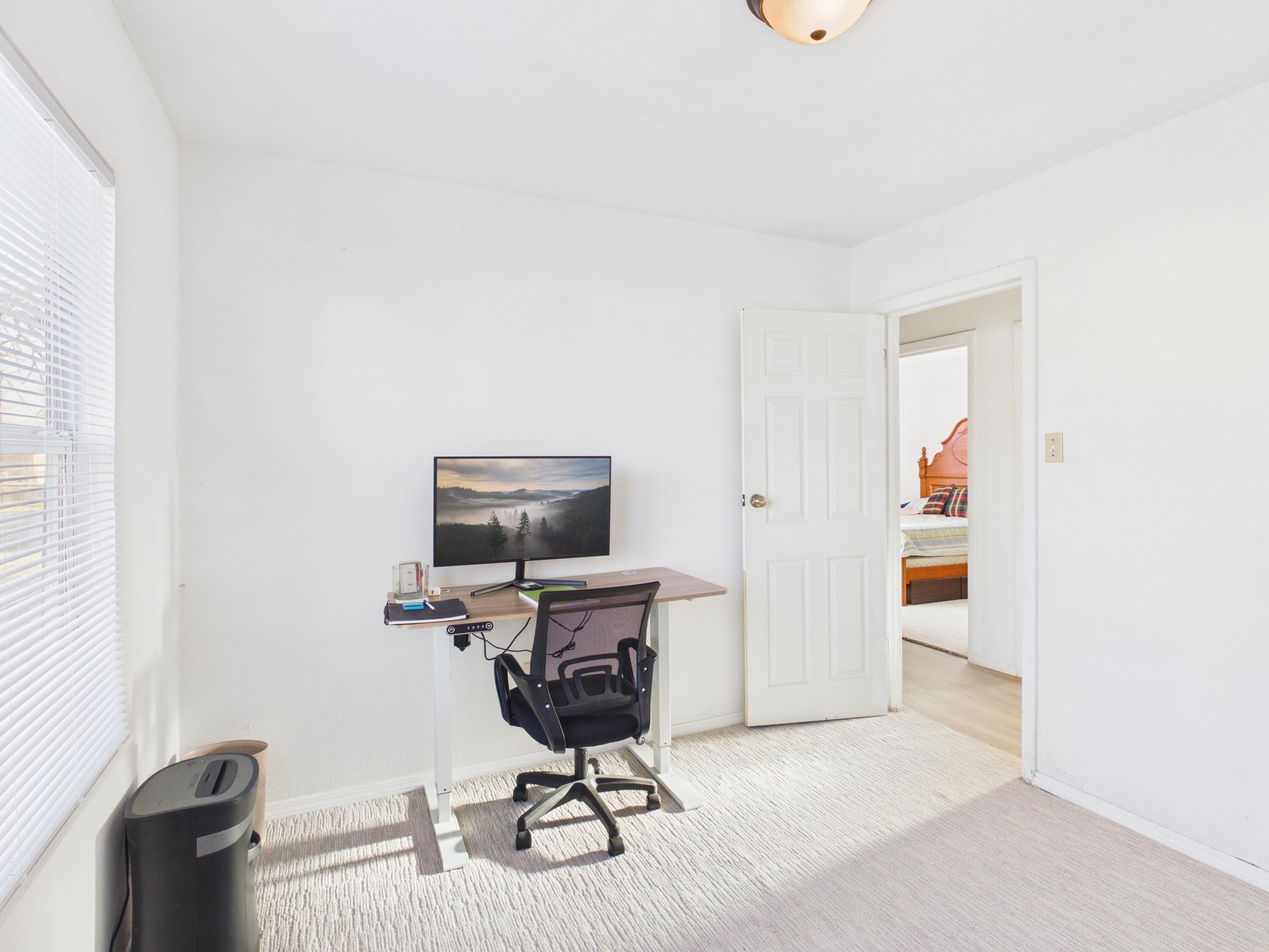 2804 Vanda Avenue Lubbock, TX 79404 - Photo 14 of 23 a view of a workspace with furniture and a window