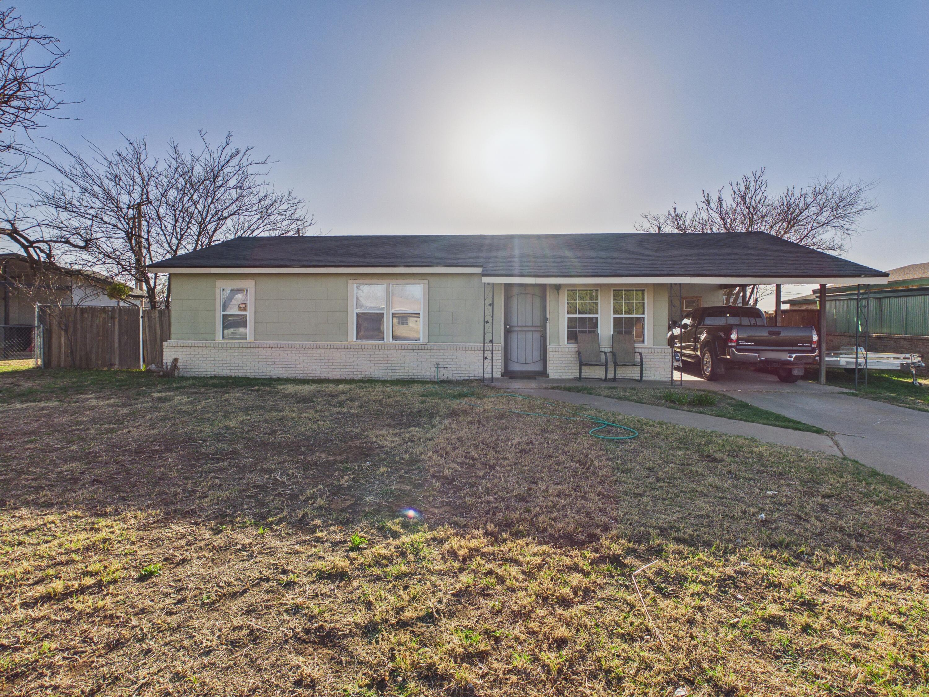 2804 Vanda Avenue Lubbock, TX 79404 - Photo 3 of 23 a front view of a house with a garden
